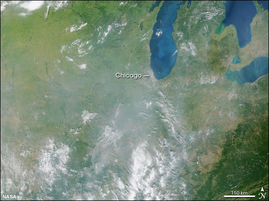 This image from the Moderate Resolution Imaging Spectroradiometer (MODIS) shows the polluted air like a gray veil over the region southwest of Chicago on September 9, 2002.