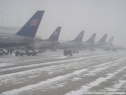 photo of planes parked at terminal during snowstorm and low visibilities in Chicago