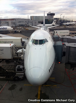 Head on view of plane at airport gate.