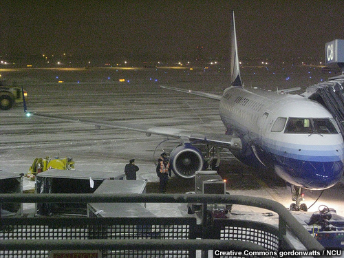 photo of plane on snowy tarmac at Chicago O'Hare International Airport