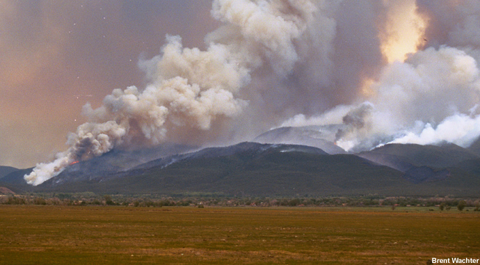 Spot fires have started on mountain slopes downwind of the Encebado fire.