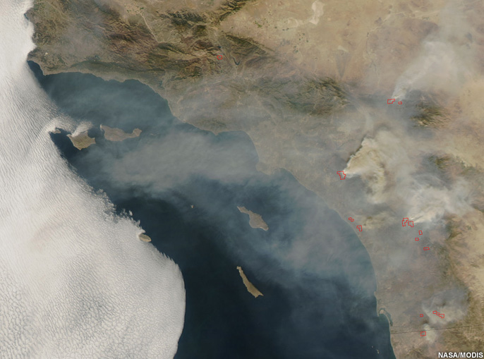 Satellite image of smoke plumes drifting inland from wildfires along the Southern California coast.