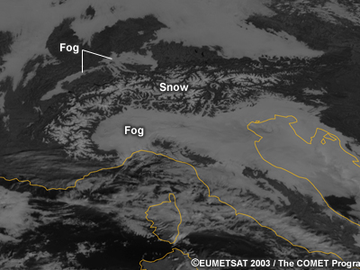 A visible satellite image of valley fog persistence. There is fog in many locations around an elevated terrain. The fog has dissipated in smaller valleys but persisted in several of the larger valleys.