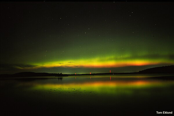 Energetic aurora with a red lower edge.