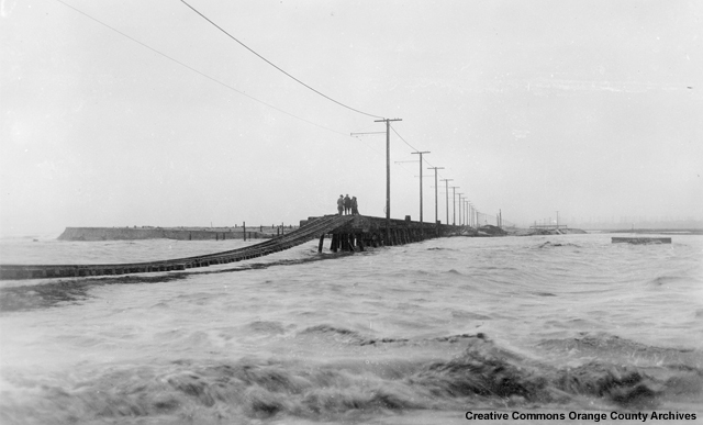1927 flood: Photo of Thousand Food channel when impounded flood waters broke through to the Pacific Ocean. The Coast Blvd. & P.E. [Pacific Electric] Railroad suffered extreme damage as shown.