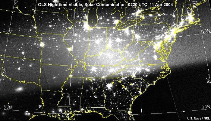 DMSP OLS nighttime visible image over the central and eastern U.S. during three-quarter moon conditions showing solar glare as direct sunlight enters the OLS instrument; taken during night at 0220 UTC on April 11, 2004.