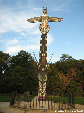 The crests carved upon the totem pole represent Kwanusila, the Thunderbird, a whale with a man on its back, and a sea monster. 