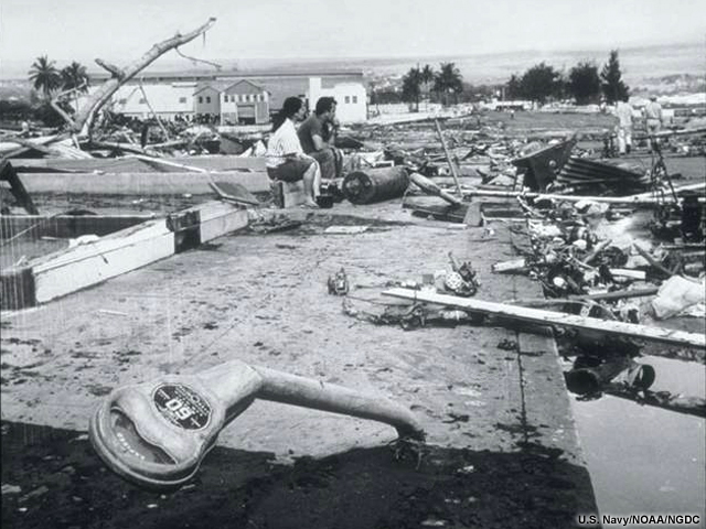The Waiekea area of Hilo, Hawaii 1960. The force of the debris filled tsunami bent parking meters.