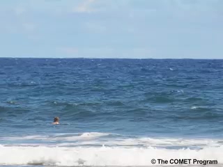 Swimmer in breaking waves.
