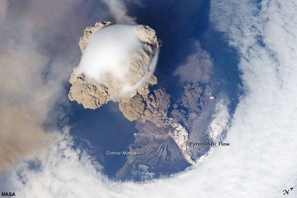 This is a view from space of the eruption of Sarychev volcano. The plume appears to be a combination of brown ash and white steam. The vigorously rising plume gives the steam a bubble-like appearance.