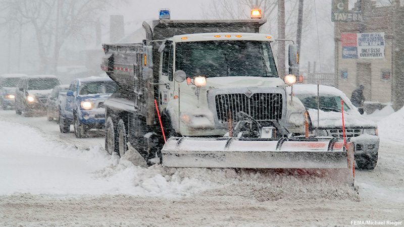 Plow works to keep street passable as a blizzard hits Denver, Colorado.